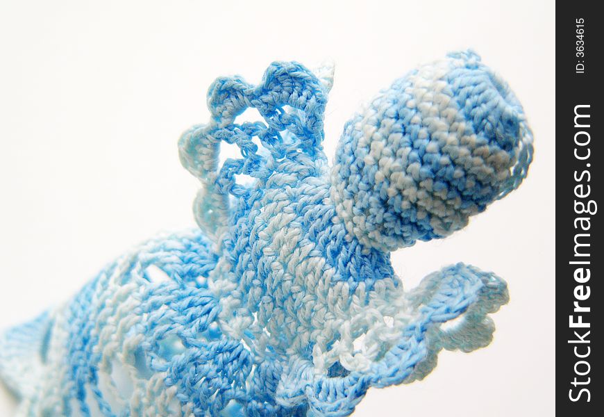 Detail of blue-white christmas crochet angel. Christmas decorations on a white background