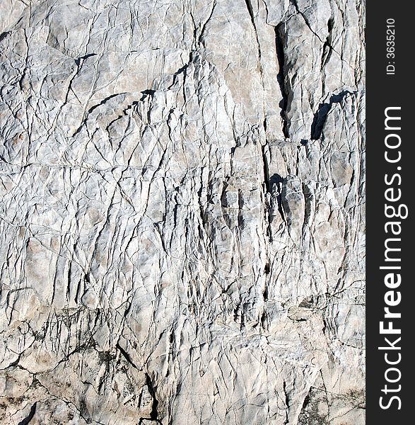 Rugged natural grey limestone surface. Rugged natural grey limestone surface