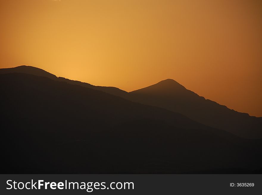 Sunrise behind mountain in Volos