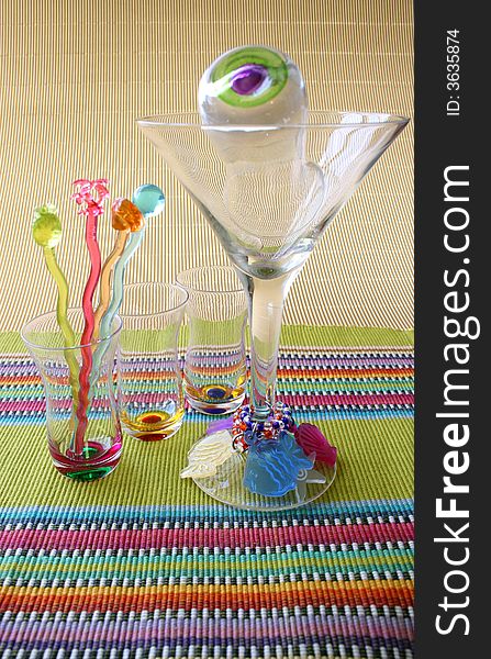 Martini Glass and Cocktail Sticks on a colorful placemat. Martini Glass and Cocktail Sticks on a colorful placemat
