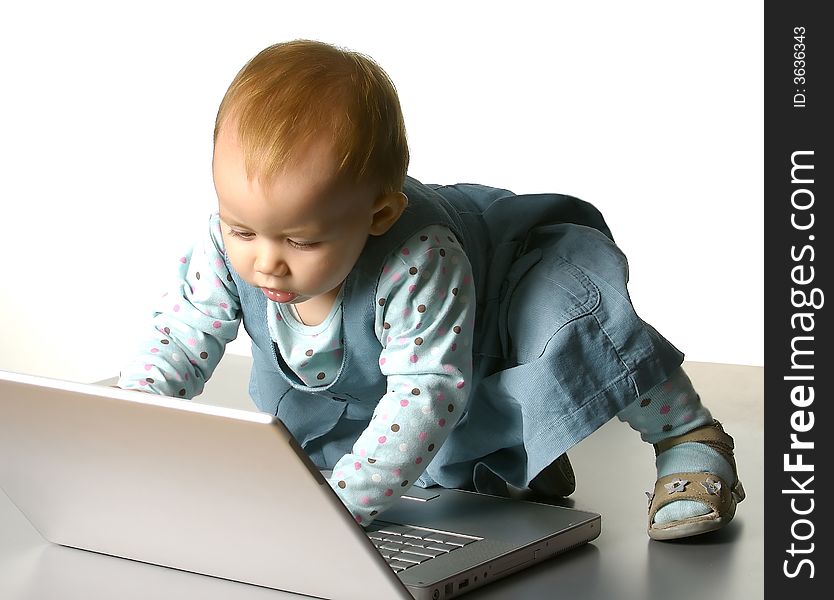 The little girl with a computer on a white background