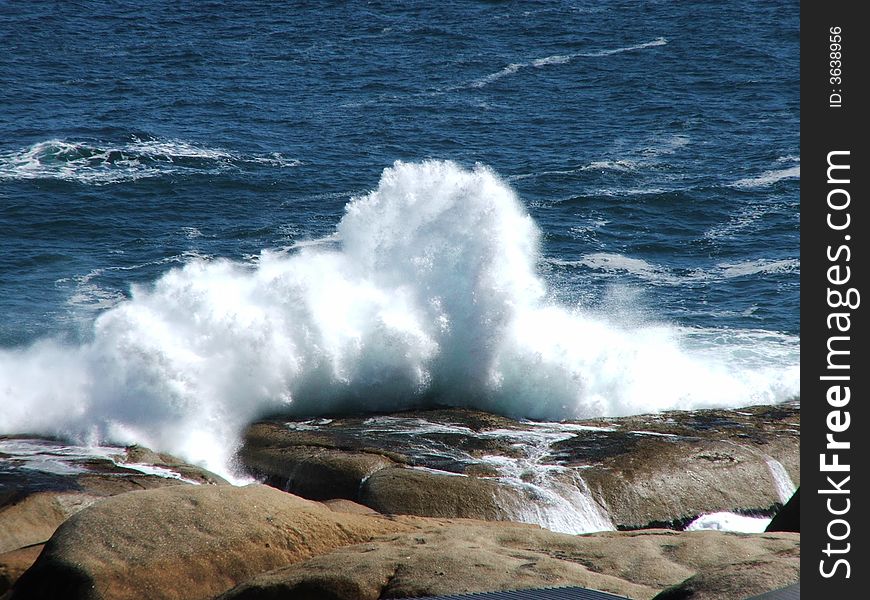 Waves crashing against rocks near Llandudno, Cape Town