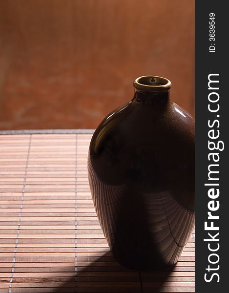 Pretty ceramic jug on a bamboo napkin