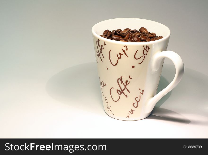 Coffee beans in a coffee cup. Coffee beans in a coffee cup