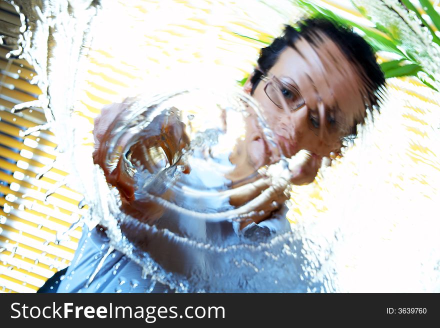 Portrait of  woman splashing water un to  the camera. Portrait of  woman splashing water un to  the camera