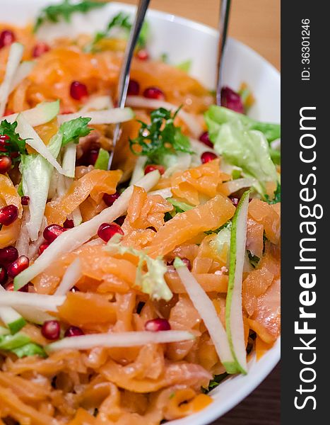 Smoked salmon, pomegranate and pears salad close-up. Smoked salmon, pomegranate and pears salad close-up