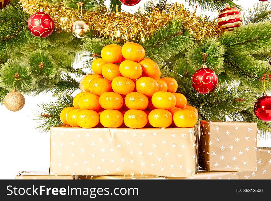 Christmas tree with gifts and presents and mandarines, isolated on white. Christmas tree with gifts and presents and mandarines, isolated on white