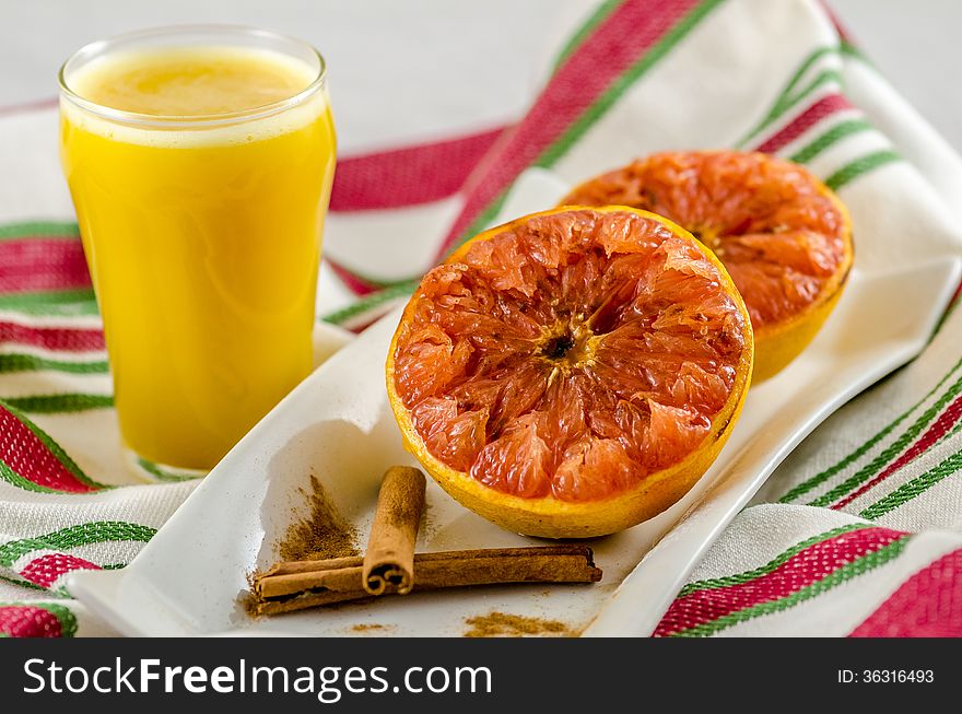 Baked graprefruit with a glass or orange juice for breakfast. Baked graprefruit with a glass or orange juice for breakfast.