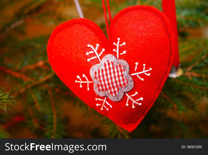 Red Christmas heart decoration on a tree. Red Christmas heart decoration on a tree