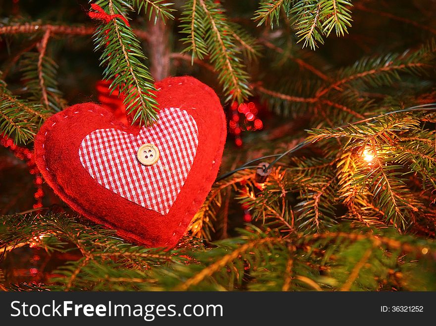 Red Christmas heart decoration on a tree. Red Christmas heart decoration on a tree