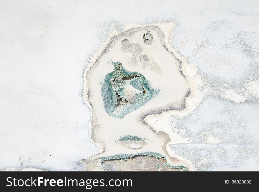 Closeup of a damaged fiberglass boat hull showing hole and cracks. Closeup of a damaged fiberglass boat hull showing hole and cracks.