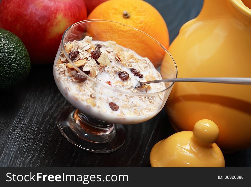 Glass bowl with muesli and milk near fruits. Glass bowl with muesli and milk near fruits