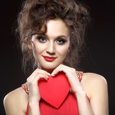 Girl In Red Dress Keeps The Heart. Concept Of Valentine S Day Royalty Free Stock Photography Girl In Red Dress Keeps The Heart. Concept Of Valentine S Day Royalty Free Stock Photography