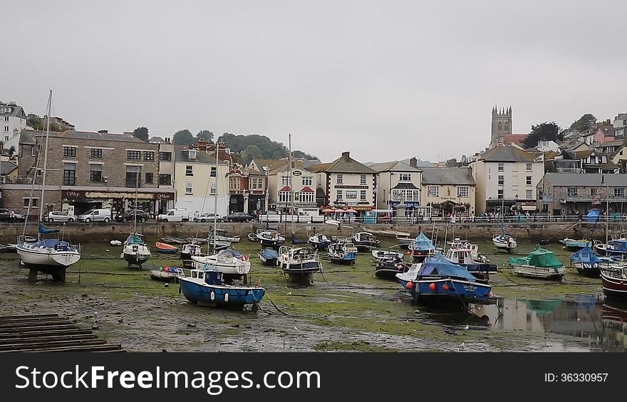Low tide Brixham harbour Devon on overcast day in summer