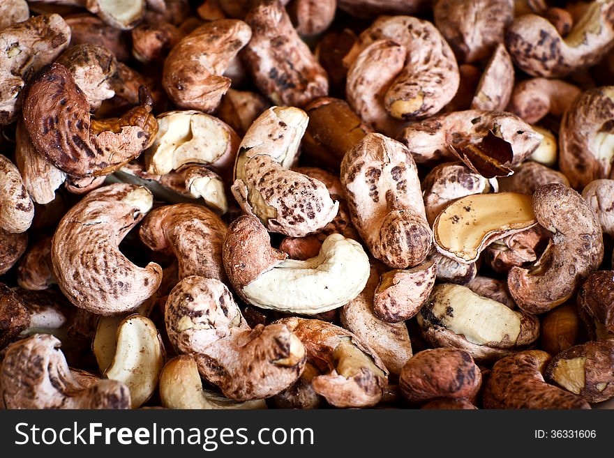 Cashew nuts with shells on a background