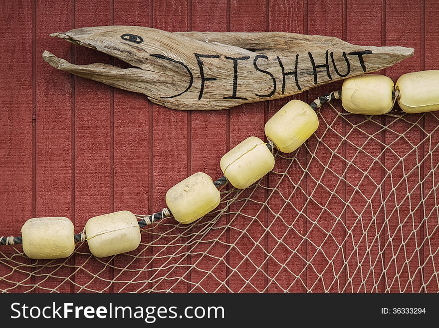 Sign on a house of fisherman with net