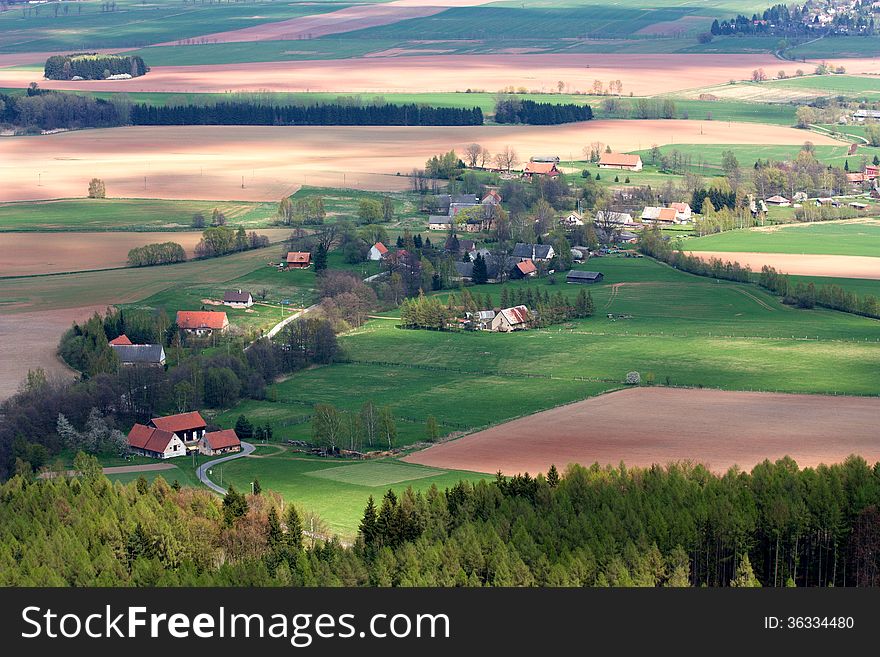 Village in the countryside with fields and forests around