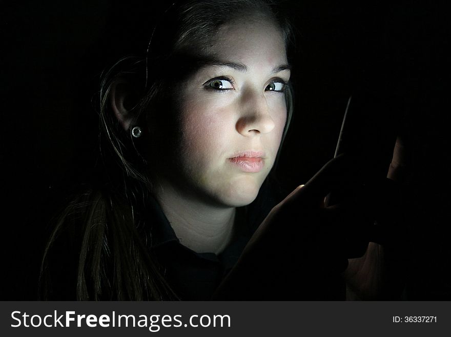 Teen Girls Face Lit By Cell Phone