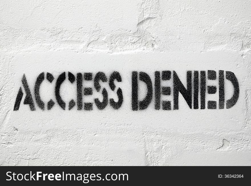 Access denied black stencil print on the white brick wall