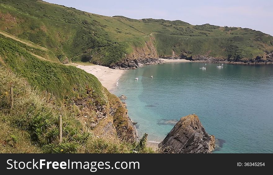 Lantic Bay Cornwall England near Fowey and Polruan with turquoise and blue sea on a beautiful summer day. Lantic Bay Cornwall England near Fowey and Polruan with turquoise and blue sea on a beautiful summer day