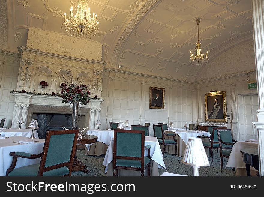 A luxury old dinning room in a lovely hotel, with an open fire place and chandeliers. A luxury old dinning room in a lovely hotel, with an open fire place and chandeliers.