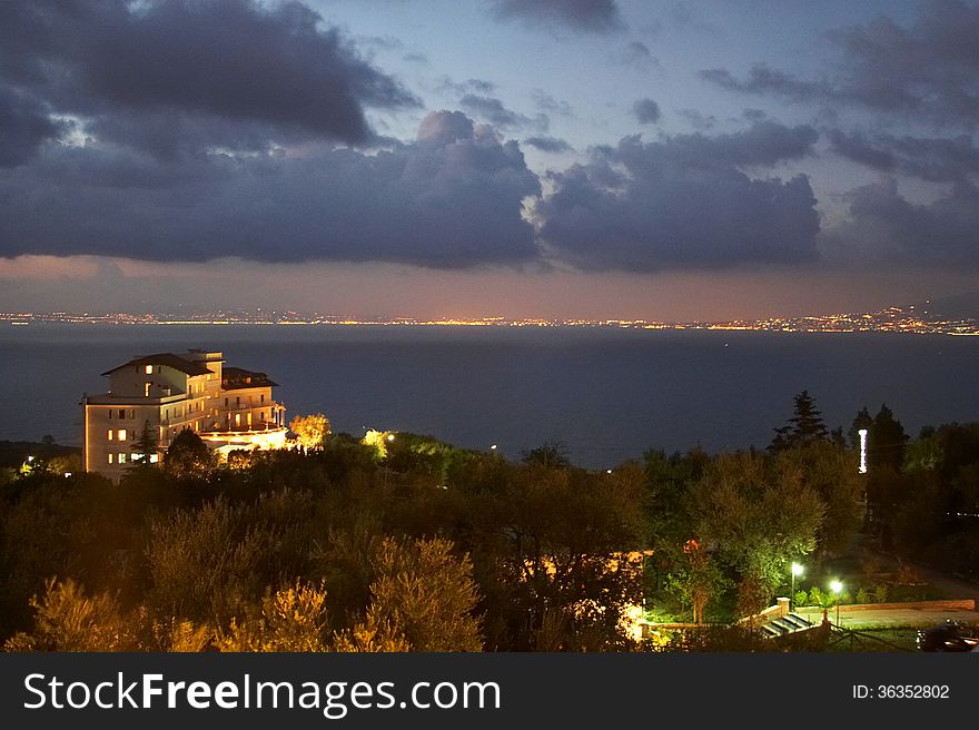 A twilight view of a villa with Sorrento Italy in the background. A twilight view of a villa with Sorrento Italy in the background