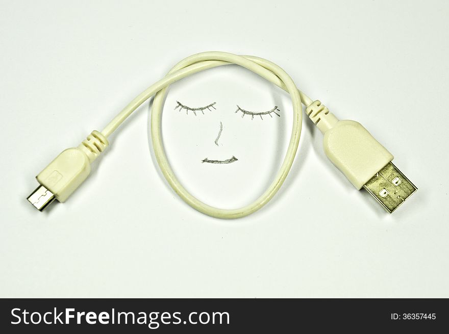 Smile and USB cable on a white background. Smile and USB cable on a white background