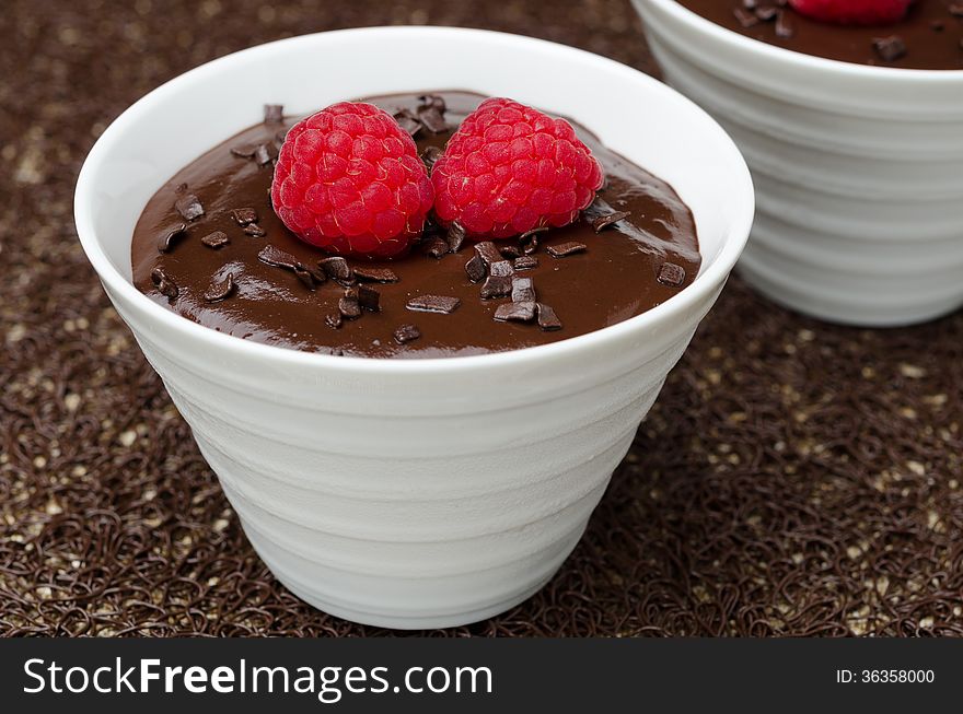 Chocolate mousse with fresh raspberries on dark background, close-up. Chocolate mousse with fresh raspberries on dark background, close-up