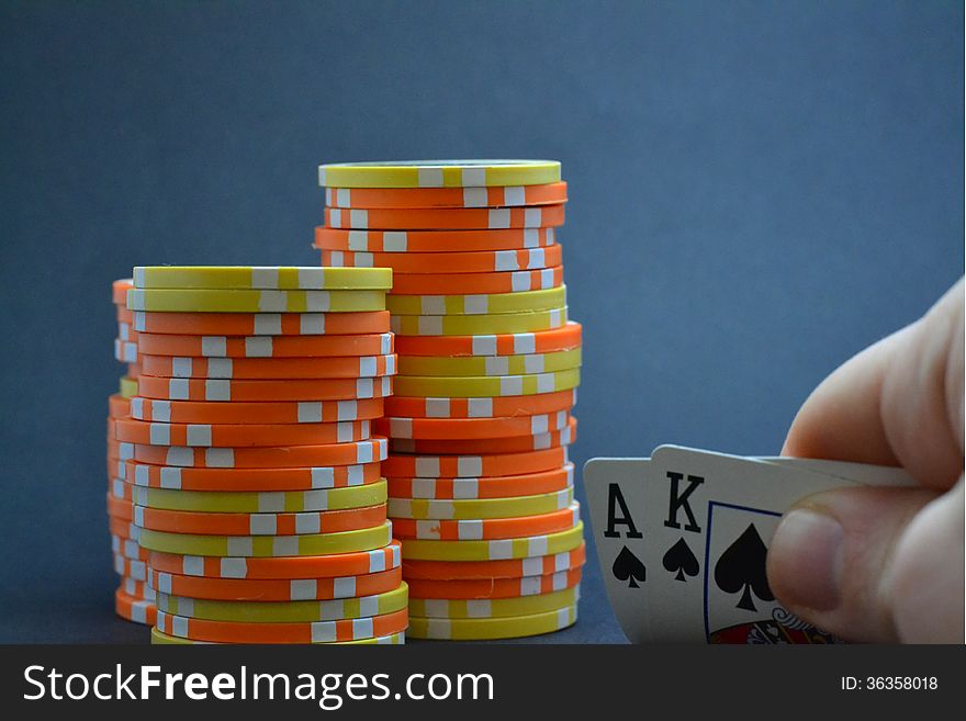 Playing cards held by hand with chips. Playing cards held by hand with chips