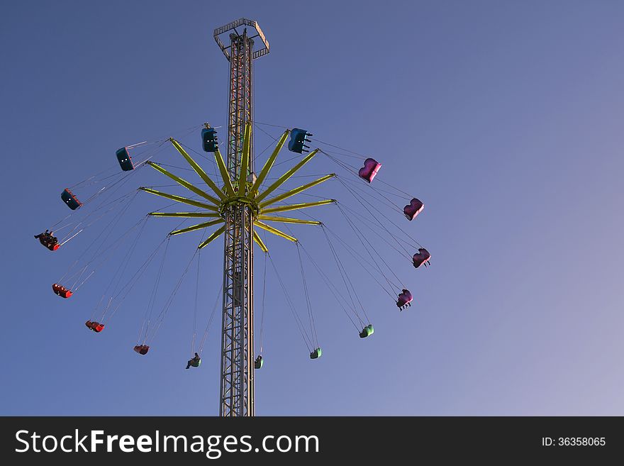 Tall funfair ride with sky background