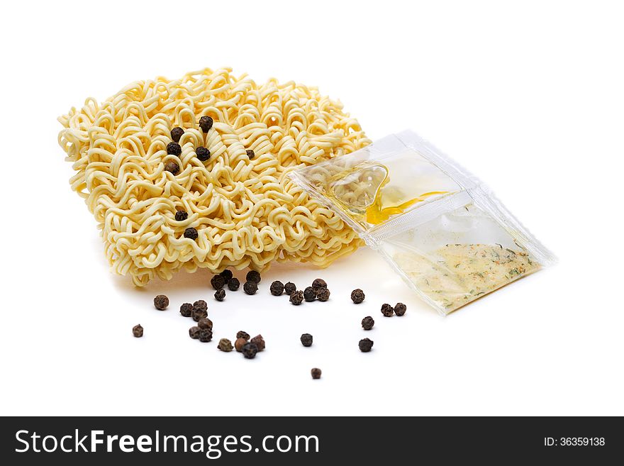 Instant noodles, a bag of spices and black pepper. Isolate on white.