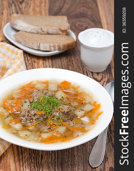 Vegetable soup with meatballs, vertical, close-up