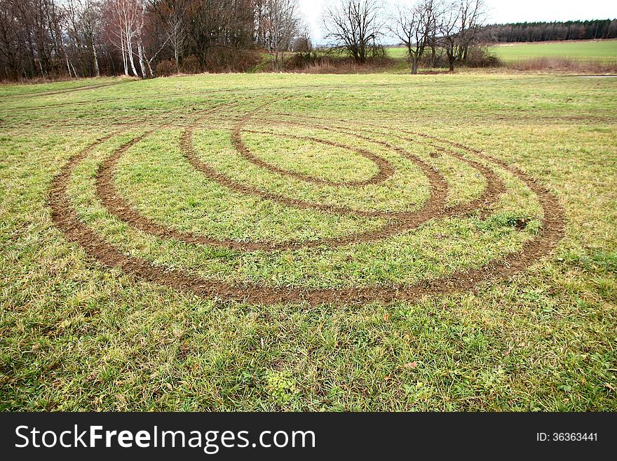 Car tracks in the meadow, ruts in the field, ruts from the rotating car in the grass. Car tracks in the meadow, ruts in the field, ruts from the rotating car in the grass