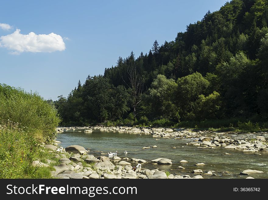 Flowing river at the base of the mountains