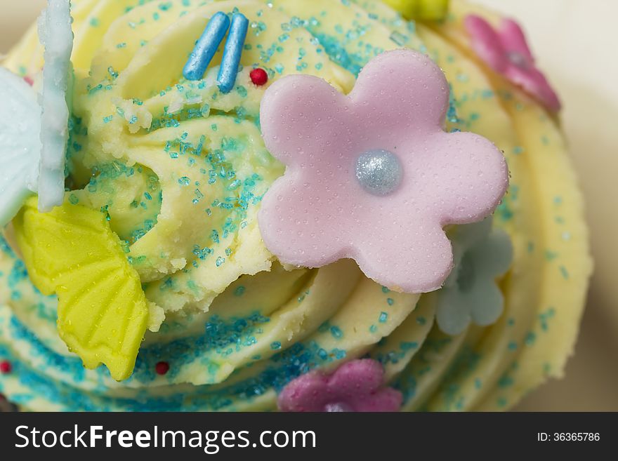 Delicious muffin with cream and sugar flowers. Delicious muffin with cream and sugar flowers