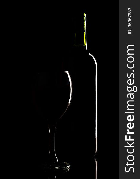 Wine bottle and glass silhouette over black