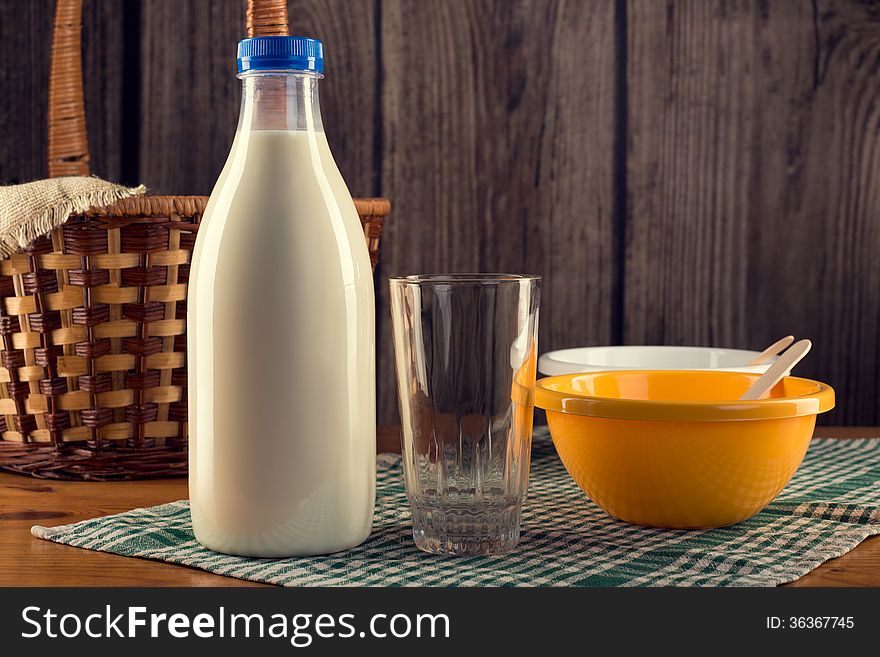 Still life of bottle of milk with empty glass