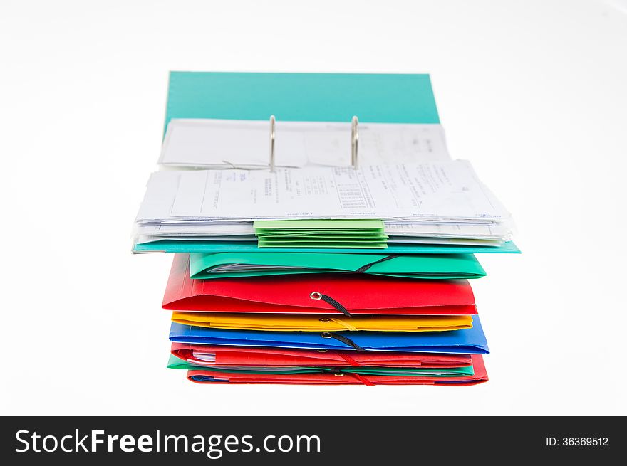 Colorful office folders and open binder with financial documents on white background. Colorful office folders and open binder with financial documents on white background