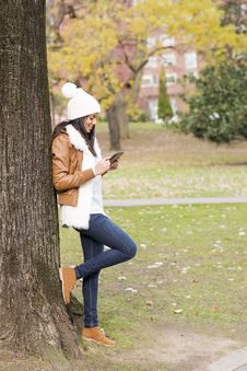 Smiling Woman Using Tablet Computer In The Park. Stock Photos Smiling Woman Using Tablet Computer In The Park. Stock Photos