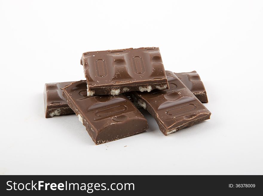 Milk chocolate with cookies on a white background.