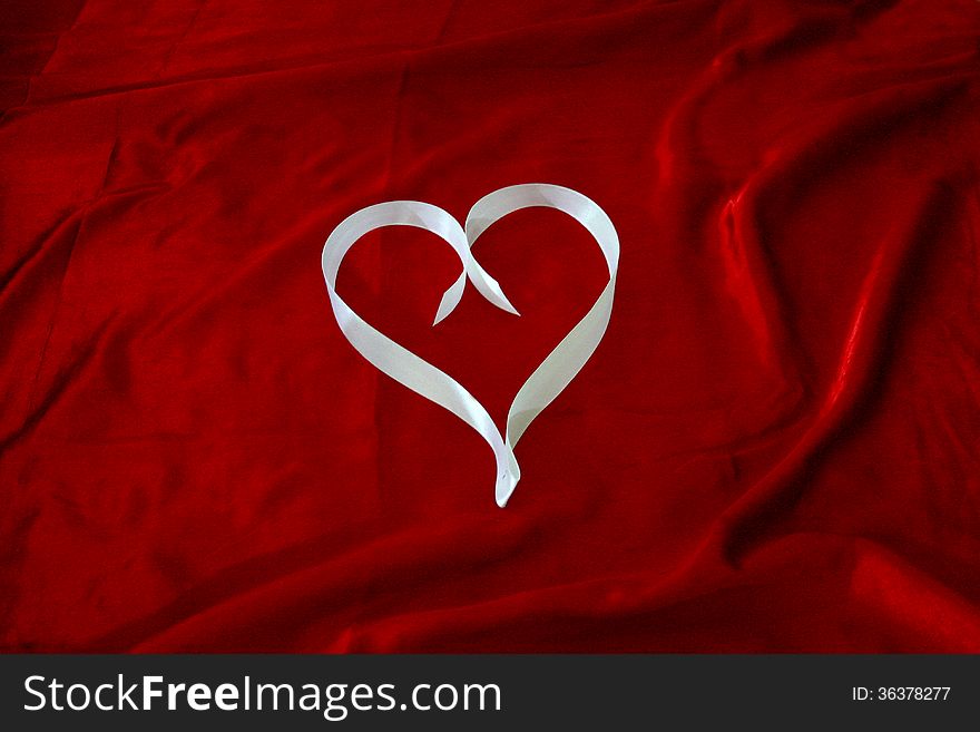 Heart in white ribbon red background for valentines day