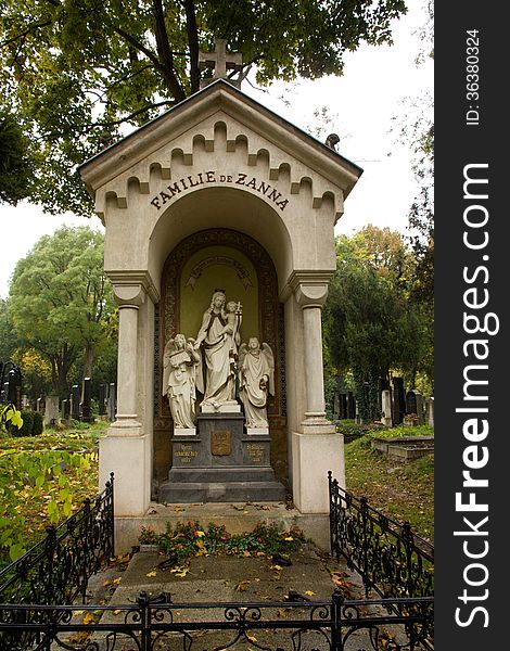 Tombstone with statues and fence. Tombstone with statues and fence