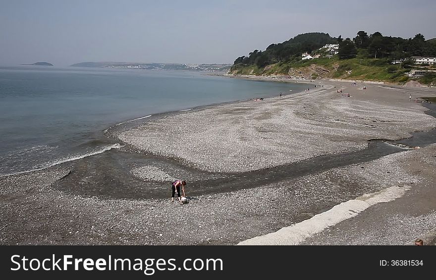 Tourists enjoying Seaton beach Cornwall near Looe England UK during the summer heatwave