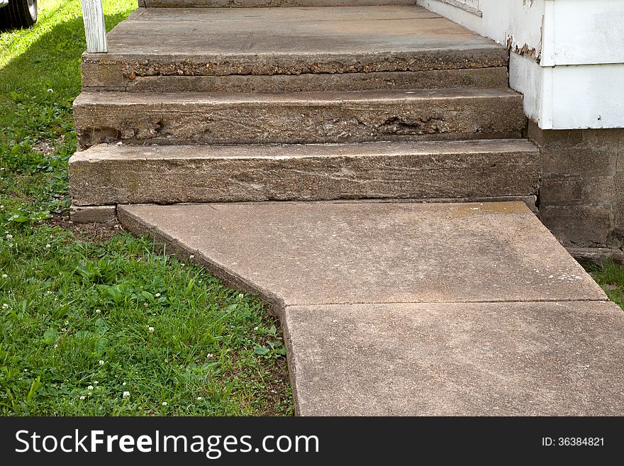 A close up of concrete stairs and sidewalk.