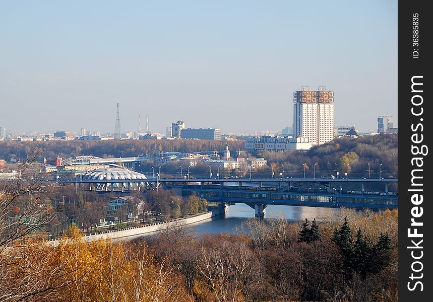 Panorama of Moscow from Sparrow hills. Autumn landscape with a view of Moskva river and a bridge across it. In the background visible to the building of the Academy of Sciences, the television tower on Shabolovka. Also you can see the dome stadium in Luzhniki.