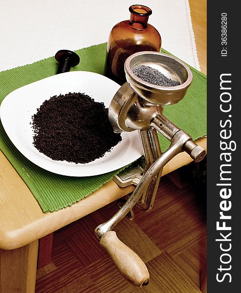 Grinding poppy seeds in a plate mill mounted on the kitchen table.