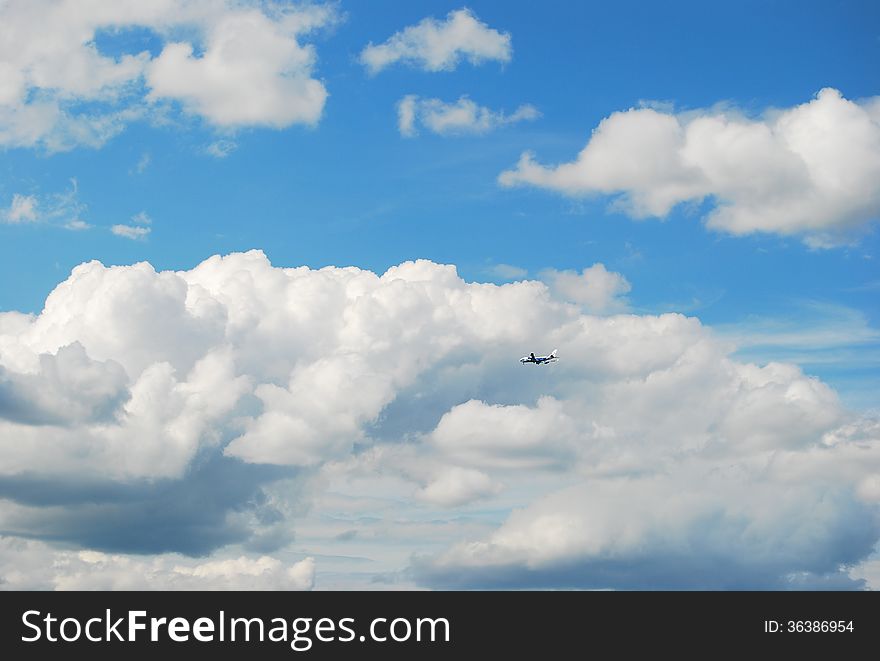 Blue sky with clouds which flies a plane