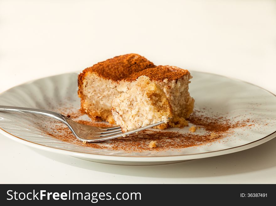 Slice of creamy cheesecake with a cinnamon topping