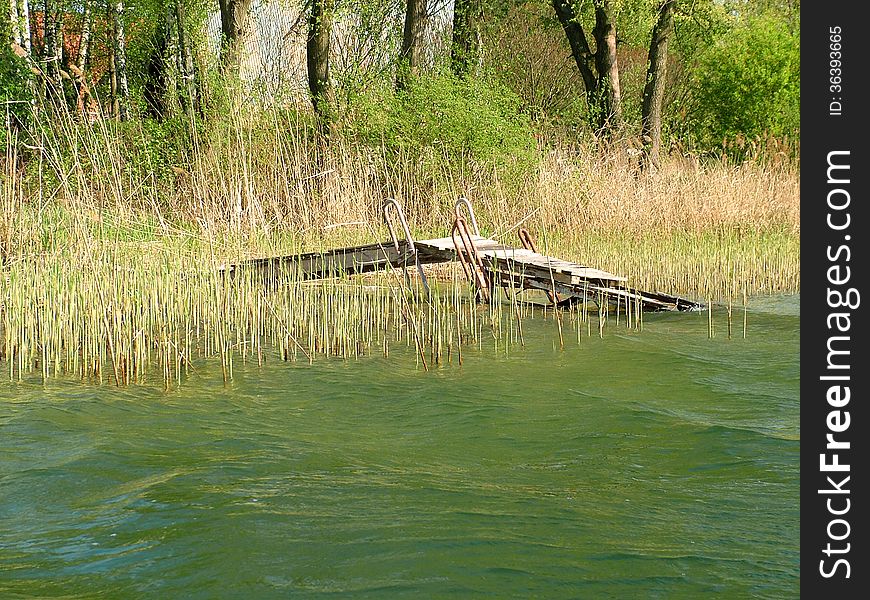 Old bridge over Lake Powidzkie in the spring season. Old bridge over Lake Powidzkie in the spring season.