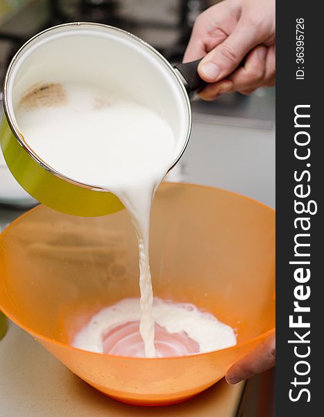 Pouring milk in a plastic bowl